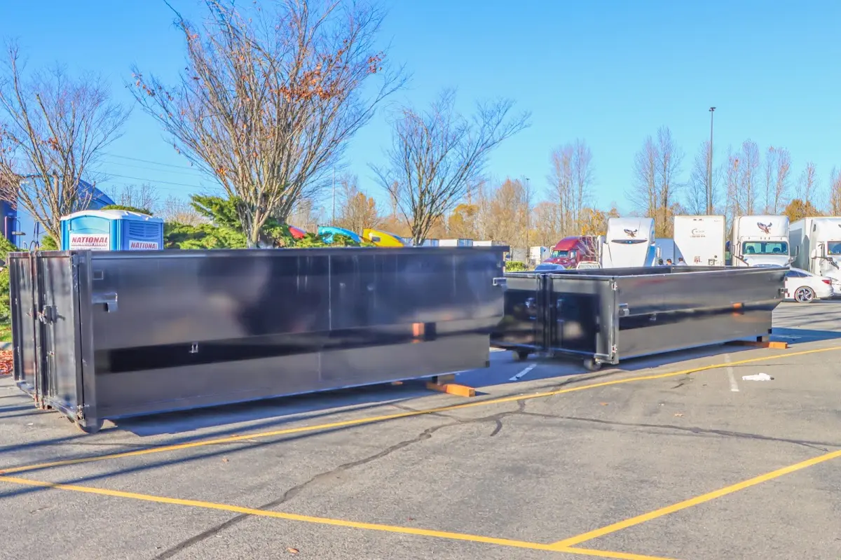 Professional dumpster rental service with roll-off container on residential driveway in Somers Point